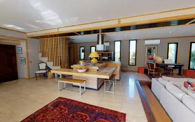 a living room with a couch and a table at Sérénité en Provence, Climatisée in La Roque-sur-Pernes