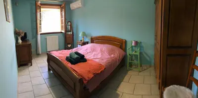 a bedroom with a bed with a stuffed animal on it at La maison des Sources in Salon-de-Provence