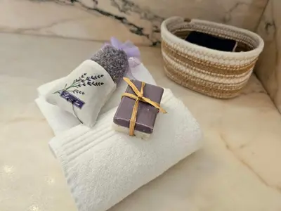 a towel with a bar of chocolate on top of it at Gîte Le Refuge in Monieux