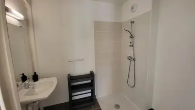 a white bathroom with a shower and a sink at maison village vacances demeures du Ventoux in Aubignan