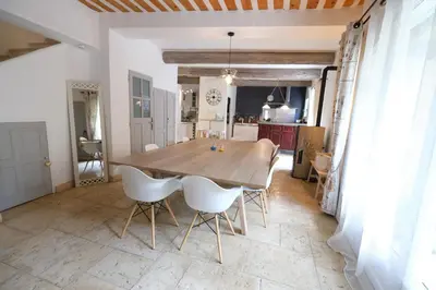 a dining room table and chairs in a kitchen at charming provencal house with private pool for 4 people in cheval blanc, luberon. in Cheval-Blanc