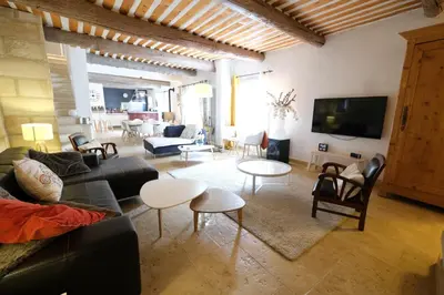 a living room with a couch and tables and a tv at charming provencal house with private pool for 4 people in cheval blanc, luberon. in Cheval-Blanc