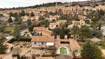 an aerial view of a village with houses at lagalerie84 in Saint-Saturnin-les-Apt