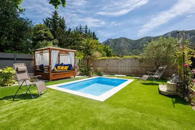 a backyard with a swimming pool and a gazebo at Errances Provençales in Saint-Rémy-de-Provence