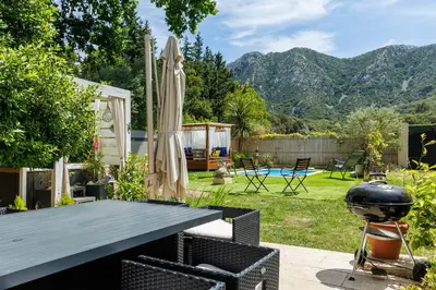 a patio with a grill and a table with a grill at Errances Provençales in Saint-Rémy-de-Provence