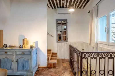 a room with a staircase and a blue wooden cabinet at La maison du château in Fontaine-de-Vaucluse