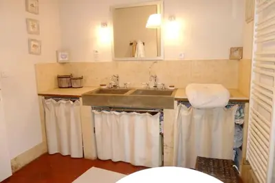 a bathroom with a sink and a mirror at Maison de 6 chambres avec piscine privée, jardin aménagé et wifi à Pernes-les-Fontaines in Pernes-les-Fontaines