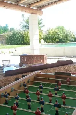 a group of men standing on a pool table at Maison de 6 chambres avec piscine privée, jardin aménagé et wifi à Pernes-les-Fontaines in Pernes-les-Fontaines