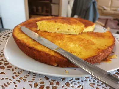 a piece of cake on a plate with a knife at BASTIDE DES MARTELIERES in Salon-de-Provence