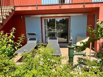 a patio with chairs and a grill on a house at BASTIDE DES MARTELIERES in Salon-de-Provence
