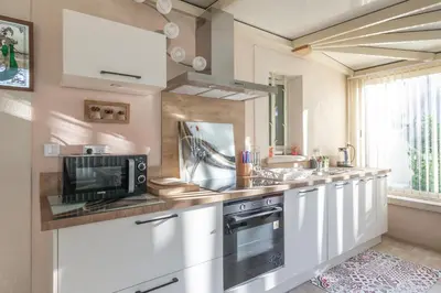 a kitchen with a sink and a microwave at Les Lauriers en Lubéron in Cheval-Blanc