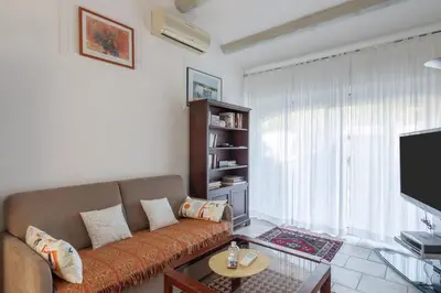 a living room with a couch and a tv at Les Lauriers en Lubéron in Cheval-Blanc