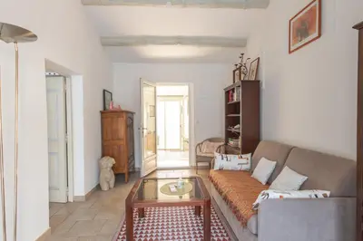 a living room with a couch and a table at Les Lauriers en Lubéron in Cheval-Blanc