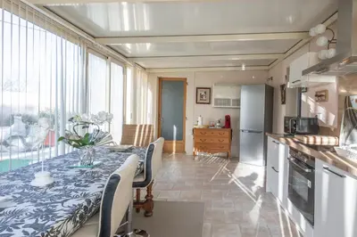 a kitchen with a table with a blue and white table cloth at Les Lauriers en Lubéron in Cheval-Blanc