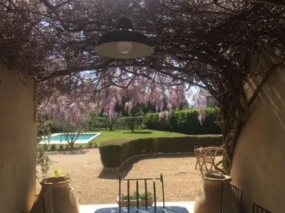 an archway leading to a garden with purple flowers at Provencal farmhouse, pool, pool house, countryside Plan d’Orgon, Provence - 8 people in Plan-dʼOrgon