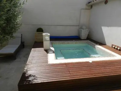a small swimming pool in the middle of a backyard at Le Maset des Aires avec vue sur le Luberon et son jacuzzi extérieur disponible de juin à mi-septembre in Maubec