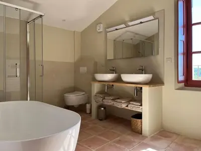 a bathroom with two sinks and a tub and a shower at La Planette in Venasque