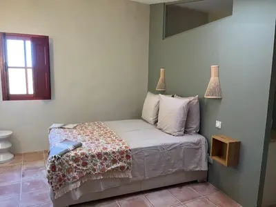 a bedroom with a bed and a mirror on the wall at La Planette in Venasque