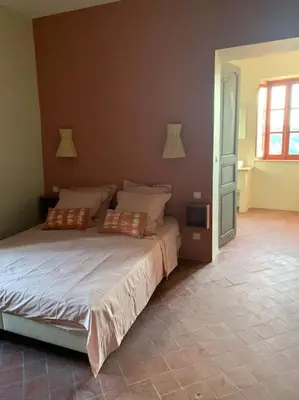 a bedroom with a bed with two pillows on it at La Planette in Venasque