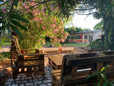 a picnic table and benches in a yard with a tree at Standing duplex FULL Equipements idéal moyen séjours in Le Thor