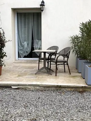 a table and two chairs sitting in front of a window at Gîte Le Nathalie Meublé de tourisme 4 étoiles Le Moulin de Prédelles in Reillanne