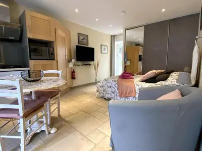 a living room with a bed and a dining room at Gîte Le Nathalie Meublé de tourisme 4 étoiles Le Moulin de Prédelles in Reillanne