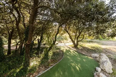 a path in a park with trees and green grass at Les Mas et Villas de Pont Royal en Provence - maeva Home - Villa 5 Pièces 8 Personnes avec piscine privée et vue sur le golf - Exclusive - super Home MAE-6074 in Mallemort
