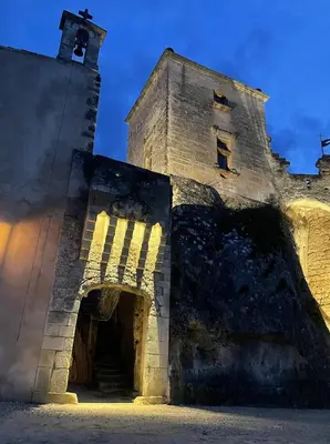 an old stone building with a tower with a door at VENTOUX in Apt