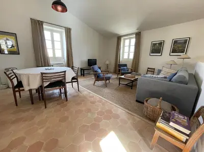 a living room with a table and a couch at VENTOUX in Apt