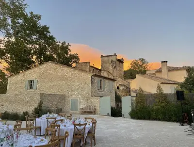 a venue with tables and chairs in front of a building at LES ROCHES in Apt