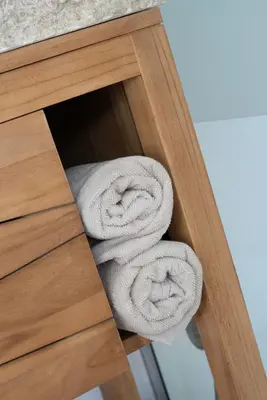 a pile of towels on a shelf in a cabinet at Lovina chambre de charme avec jacuzzi in Velaux