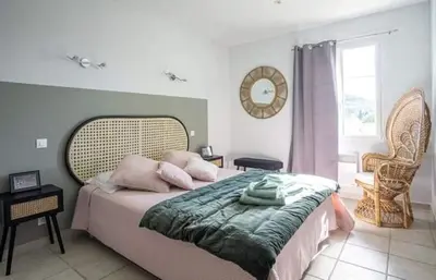a bedroom with a large bed and a window at La marinette in Fontaine-de-Vaucluse