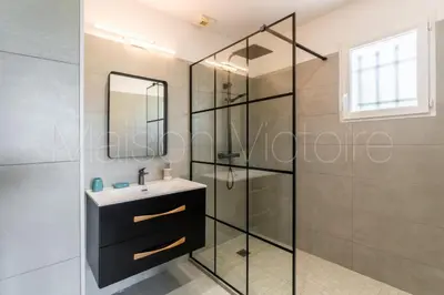 a bathroom with a sink and a glass shower at La marinette in Fontaine-de-Vaucluse