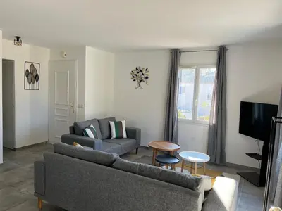 a living room with a couch and a table at Golf de Pont Royal Villa des Alpilles climatisée 3 chambres Piscine chauffée Parking et Garage in Mallemort