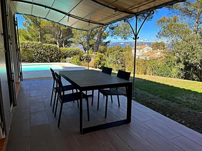 a black table and chairs on a patio at Golf de Pont Royal Villa des Alpilles climatisée 3 chambres Piscine chauffée Parking et Garage in Mallemort