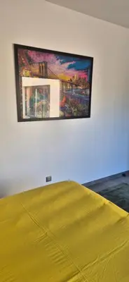 a painting hanging on a wall above a bed at Villa contemporaine in Pernes-les-Fontaines