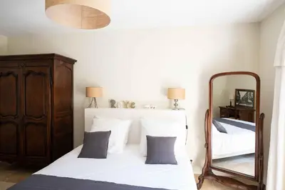 a bedroom with two beds and a mirror at Maison Cocoon Lourmarin 6 personnes in Lourmarin