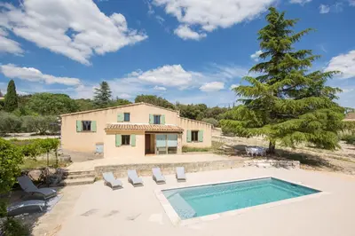 a villa with a swimming pool and a house at Maison avec piscine - Luberon in Saint-Saturnin-les-Apt