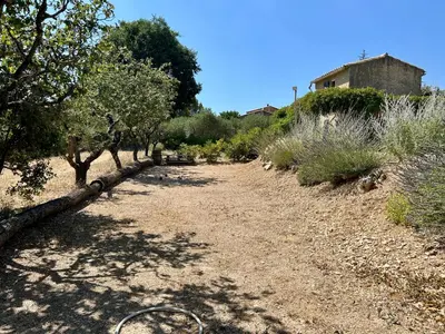 a dirt road with trees and a house in the background at Maison avec piscine - Luberon in Saint-Saturnin-les-Apt