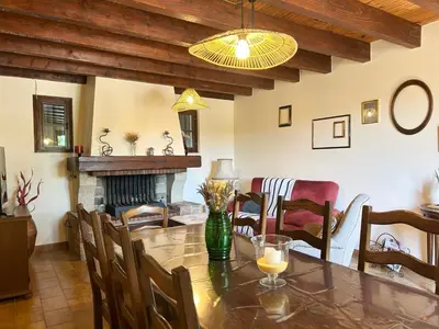 a dining room with a table and a fireplace at Maison avec piscine - Luberon in Saint-Saturnin-les-Apt