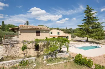 a villa with a swimming pool and a house at Maison avec piscine - Luberon in Saint-Saturnin-les-Apt
