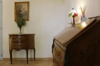 a bedroom with a bed and a table with a lamp at Les Chambres de Fanny in Cabrières-dʼAigues