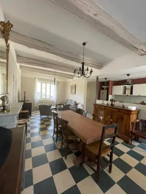 a living room with a table and chairs at Maison Rosiris in Pernes-les-Fontaines