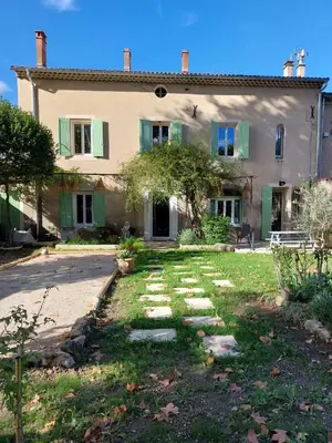 an old house with a garden in front of it at Maison Rosiris in Pernes-les-Fontaines