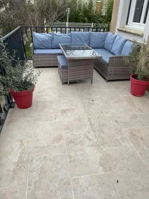 a patio with a blue couch and some plants at Villa climatisé avec piscine et jacuzzi in Carpentras