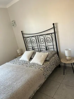 a bedroom with a bed with two pillows on it at Villa climatisé avec piscine et jacuzzi in Carpentras