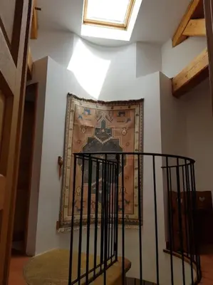 a stairway with a painting on the wall and a window at Maison de caractère dans Luberon avec piscine in Saignon