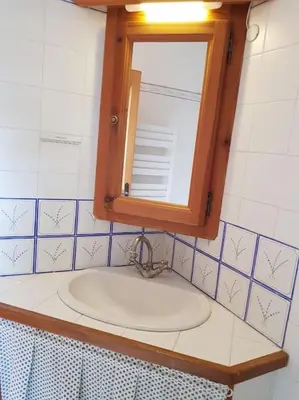a bathroom with a sink and a mirror at Maison de caractère dans Luberon avec piscine in Saignon