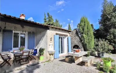 a patio of a house with a table and chairs at Lovely Home In Cheval-Blanc in Cheval-Blanc