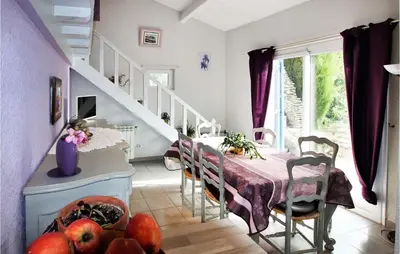 a dining room with a table and a staircase at Lovely Home In Cheval-Blanc in Cheval-Blanc